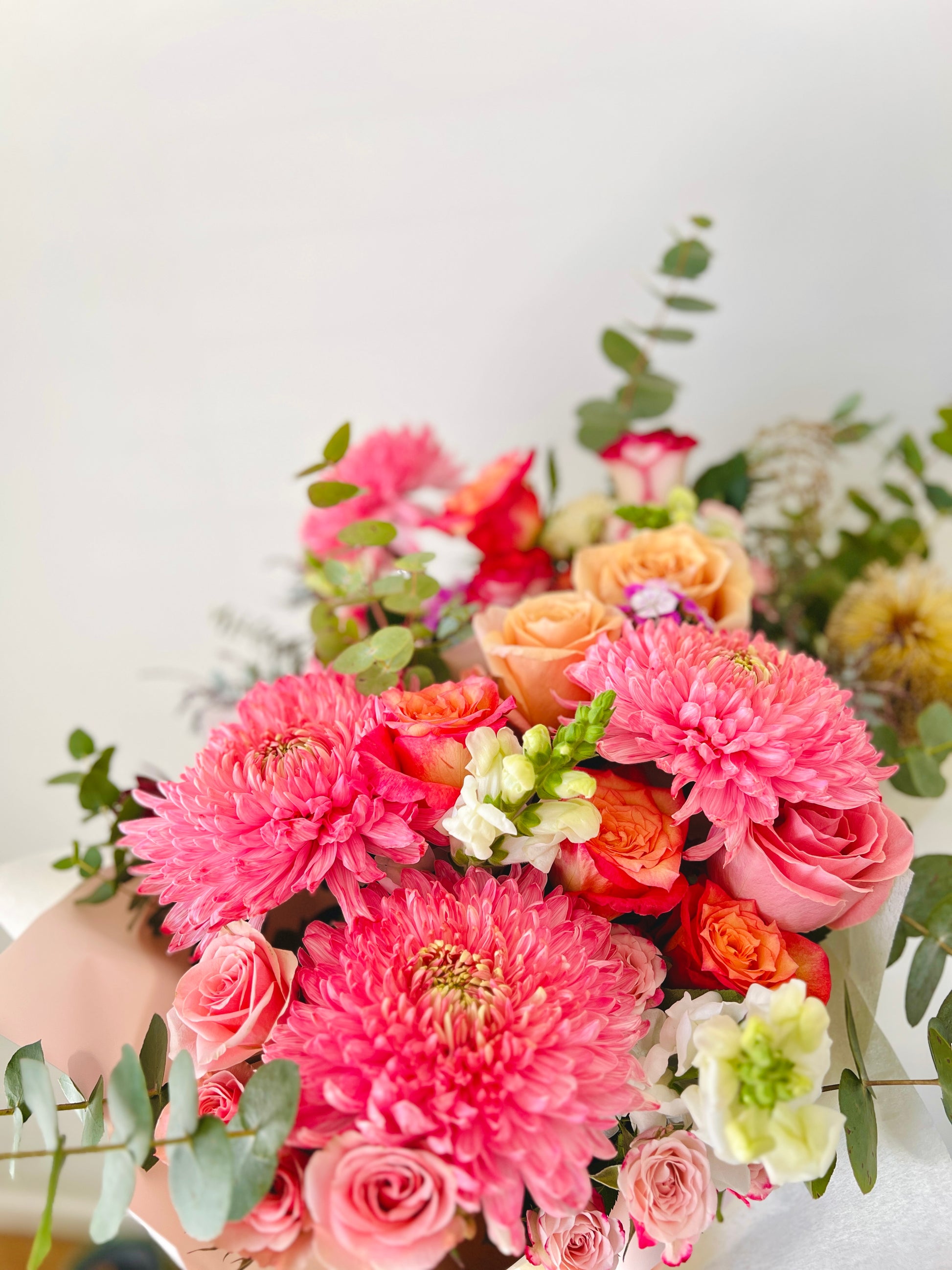 Seasonal flowers and foliages in a bouquet.