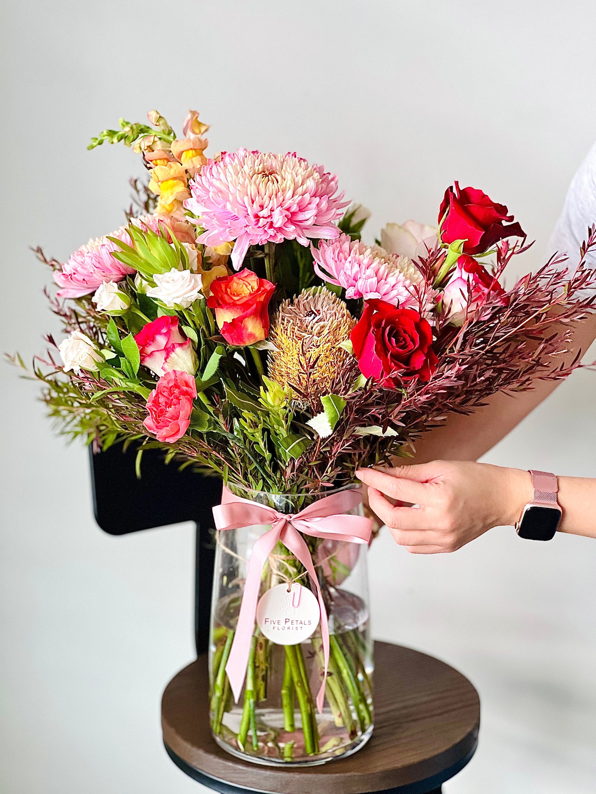 Native & seasonal flowers arranged in a glass vase.